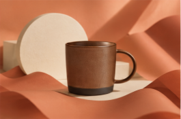 Real brown coffee mug packshot in an AI-generated graphic setting